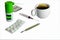 White cup of hot tea with lemon, medical thermometer, blisters with medicines, syringe isolate on a white background close-up