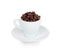 White cup and saucer filled with coffee beans