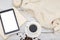 White cup, tablet, diary and plaid on a white wooden background.