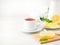 White Cup of tea, honey, honeycomb, lemon on white background. Folk method of treating colds. Side view, selective focus