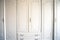 White cupboard doors with Golden key in keyhole, luxury antique design close-up wooden vintage doors