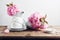 White cups  teapot and Japanese cherry blossoms