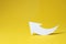 White curved paper arrow on yellow background, space for text