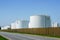 White cylindrical storage tanks for petroleum products