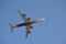 White and Dark Red Four Turbine Aircraft flying Upwards