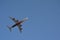 White and Dark Red Four Turbine Aircraft flying Upwards