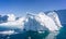 White and dazzling blue icebergs floating in the Ilulissat Icefjord in Greenland