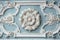 White decorative plasterwork on a light blue wall