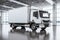White delivery truck navigates gray floor, efficient transport solution