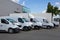 White Delivery Trucks backed Up to logistics retailer Warehouse building