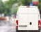 White delivery Van driving fast on city blurr bokeh street