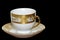 White designer cup and saucer isolated on black