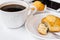 White desktop with cup of coffee, plate with muffin and smartphone, styled image for social media