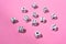 White dice with black dots on a pink background