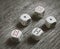 White dice on dark background. Gambling devices. Copy space for text. All number five.
