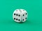 White dice green table