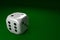 White dice lying on green table