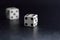 White dice pair on black background