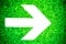 White directional arrow pointing towards right painted on a bright green grungy irregular wooden texture