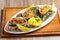 White dish with baked oyster shell cheese, salad oysters, served