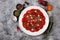 White dish with beef carpaccio with arugula