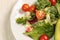 White dish with fresh leaf salad, cherry tomatoes, cucumber and avocado. Proper balanced detox diet.