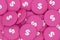 White dollar sign lined up on pink buttons as background for all the topics around finances and business