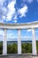 White doric columns blue sky with clouds