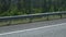 White dotted line and road fencing on city asphalt road background. high speed