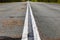 White double continuous strip on the asphalt