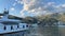 White double-deck yacht is moored off the coast of a resort town