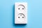 White double socket isolated on blue background. Electric lighting