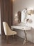 White dressing table with decor, mirror and sconces on the wall. White soft chair