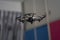 White drone flys in the air inside resident playing with motion blur throtles or copter