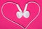 White earphone on pink background, heart