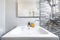 White earthenware sink next to a shower screen in a toilet