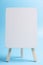 White easel front blue background
