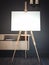 White easel stands next to dark wall, 3d rendering