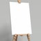 White easel stands next to grey wall, 3d rendering