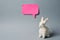 White Easter bunny with pink sticky note on gray background decoration animal Copy Space