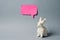 White Easter bunny with pink sticky note on gray background decoration animal Copy Space