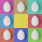 White Easter eggs on a multicoloured square background, with copy space