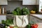 White eco friendly shopping bag with fresh vegetables. Linen tote shopper bag on modern kitchen table