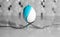 White egg balanced on two forks with the blue liguid.