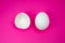 White egg and  eggshell on the pink background. Copy space. Minimalism, original and creative photo. Beautiful wallpaper. Easter