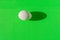 White egg on a green background. There is a clear shadow. Template