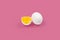 White egg and yolk.. Raw eggs on pastel pink background