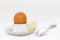 White eggcup with brown egg, spoon and butter with salt