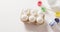 White eggs with colorful paints and brush on white background with copy space