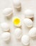 White eggs lined up on a white background